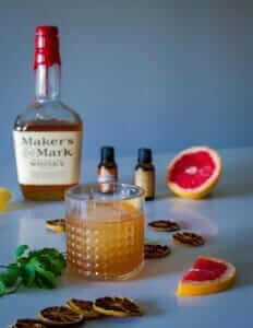 A bourbon cocktail with an orange garnish served in a rustic Bardstown setting, capturing the essence of Day 2 on the Kentucky Bourbon Trail.