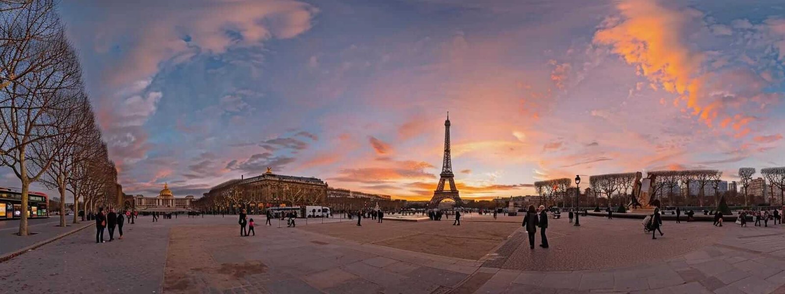 capture the iconic eiffel tower standing tall against a pastel-colored sky at dusk in paris.