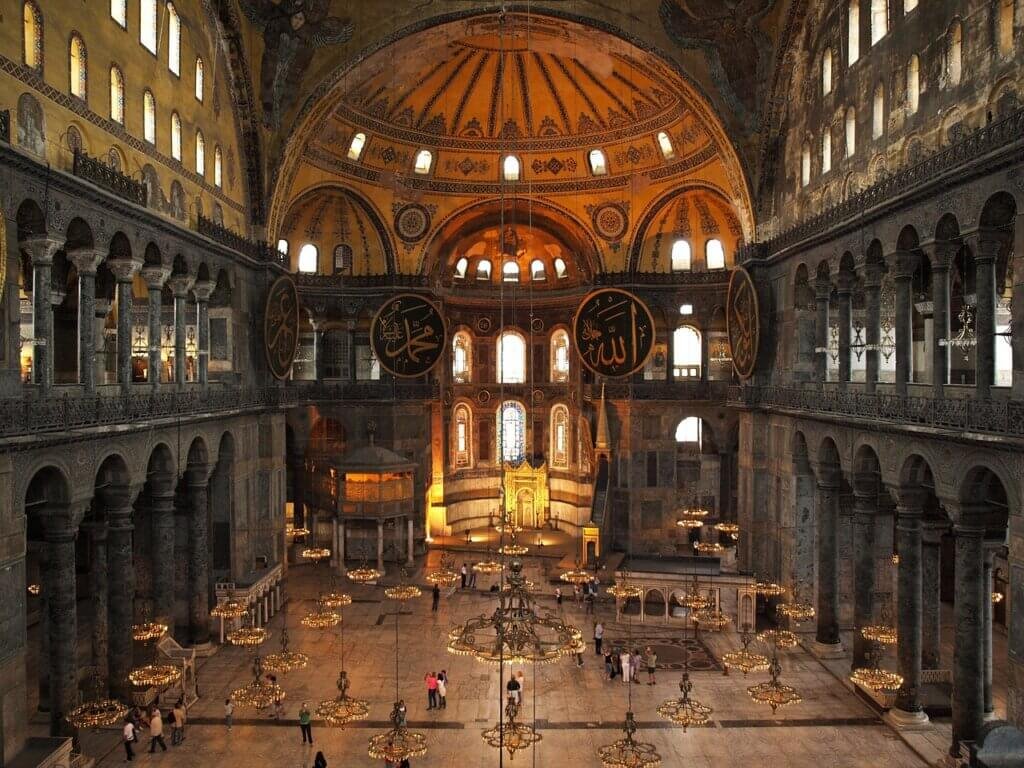 The interior of Hagia Sophia in Istanbul, Turkey, showcasing its grand dome, chandeliers, and intricate Byzantine and Ottoman design.