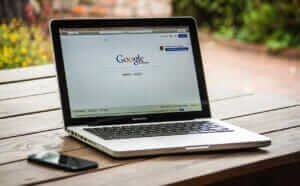 Open laptop displaying the Google homepage, symbolizing online tools for setting up fare alerts for cheap flights.