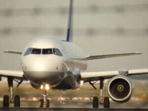 Close-up view of a passenger airplane on the runway, representing tools for booking cheap flights.